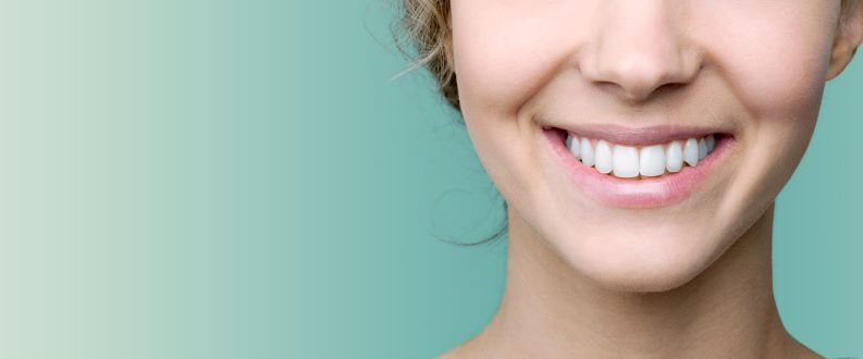 woman smiling with white smile green background
