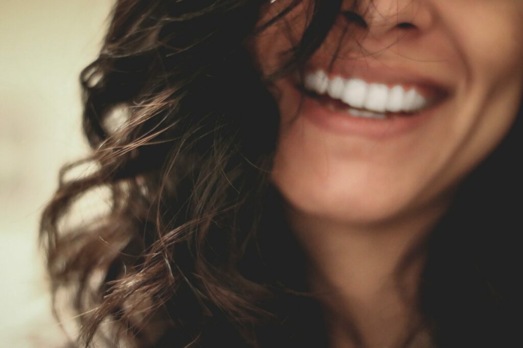 woman with curly hair with bright smile